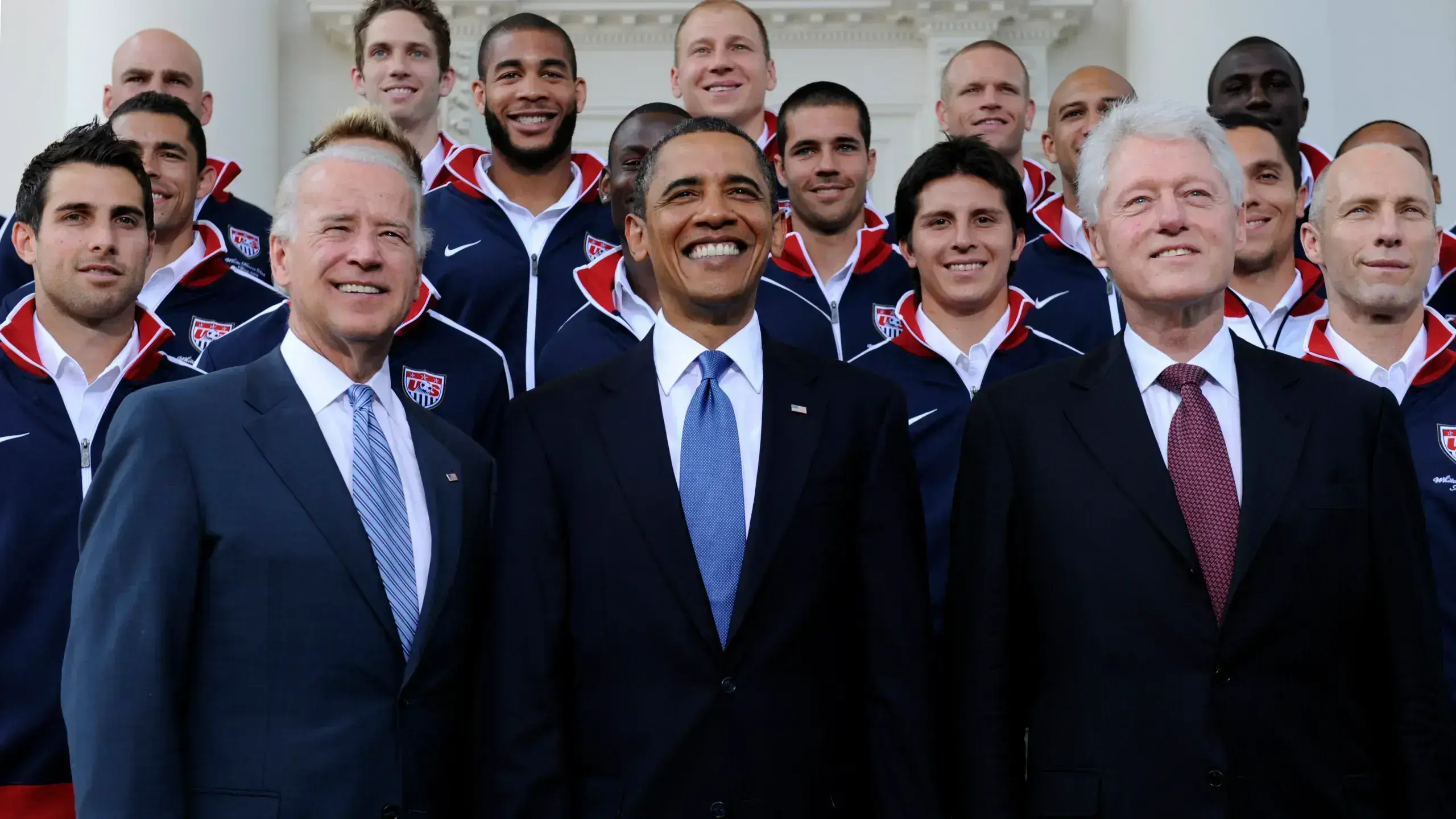 World leaders convening at a summit, contemplating the implications of Biden's assertion about Trump's international standing.