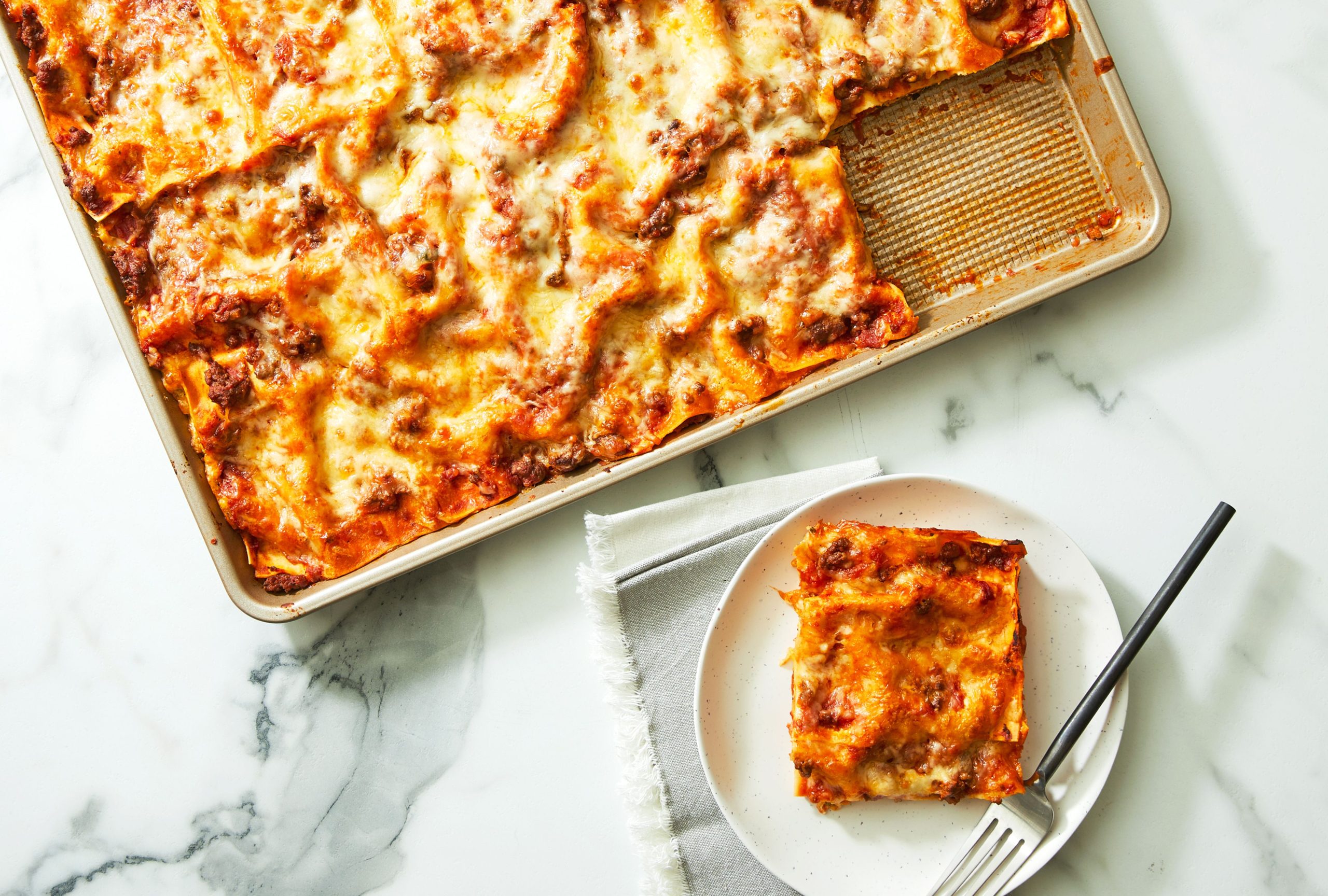 A delicious slice of homemade lasagna with golden, bubbly cheese.